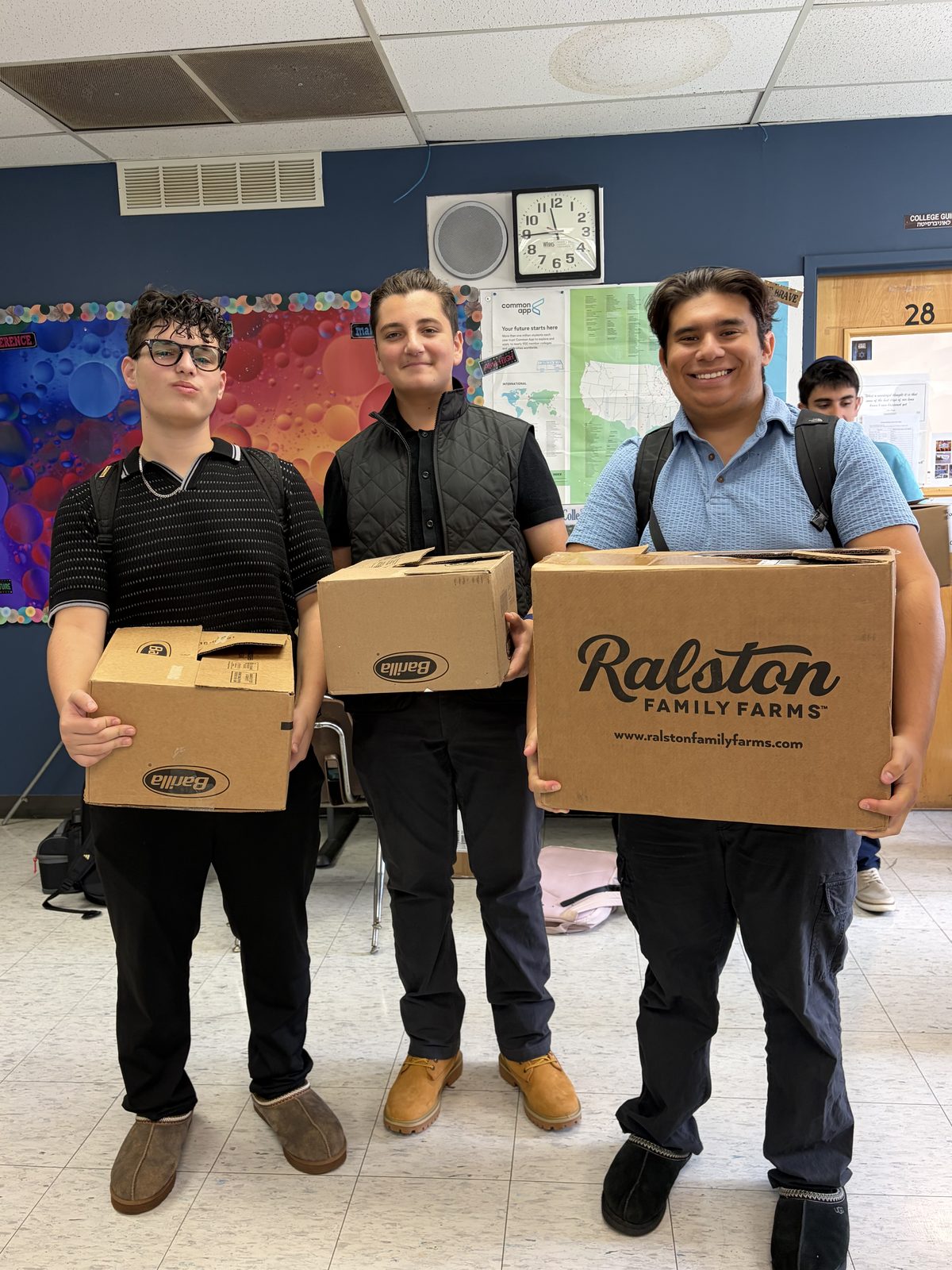 WHHS students carrying donation boxes for a chessed drive