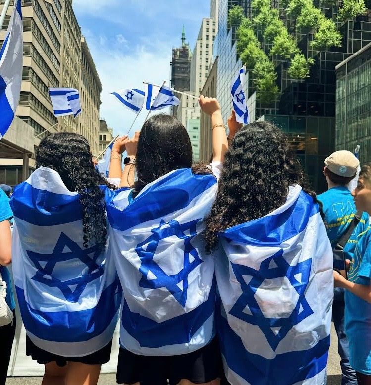 WHHS students wrapped in Israeli flags at the Celebrate Israel Parade