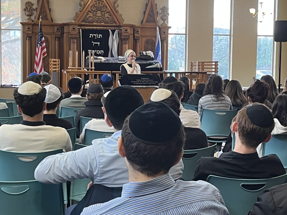 A speaker addressing WHHS students in the shul